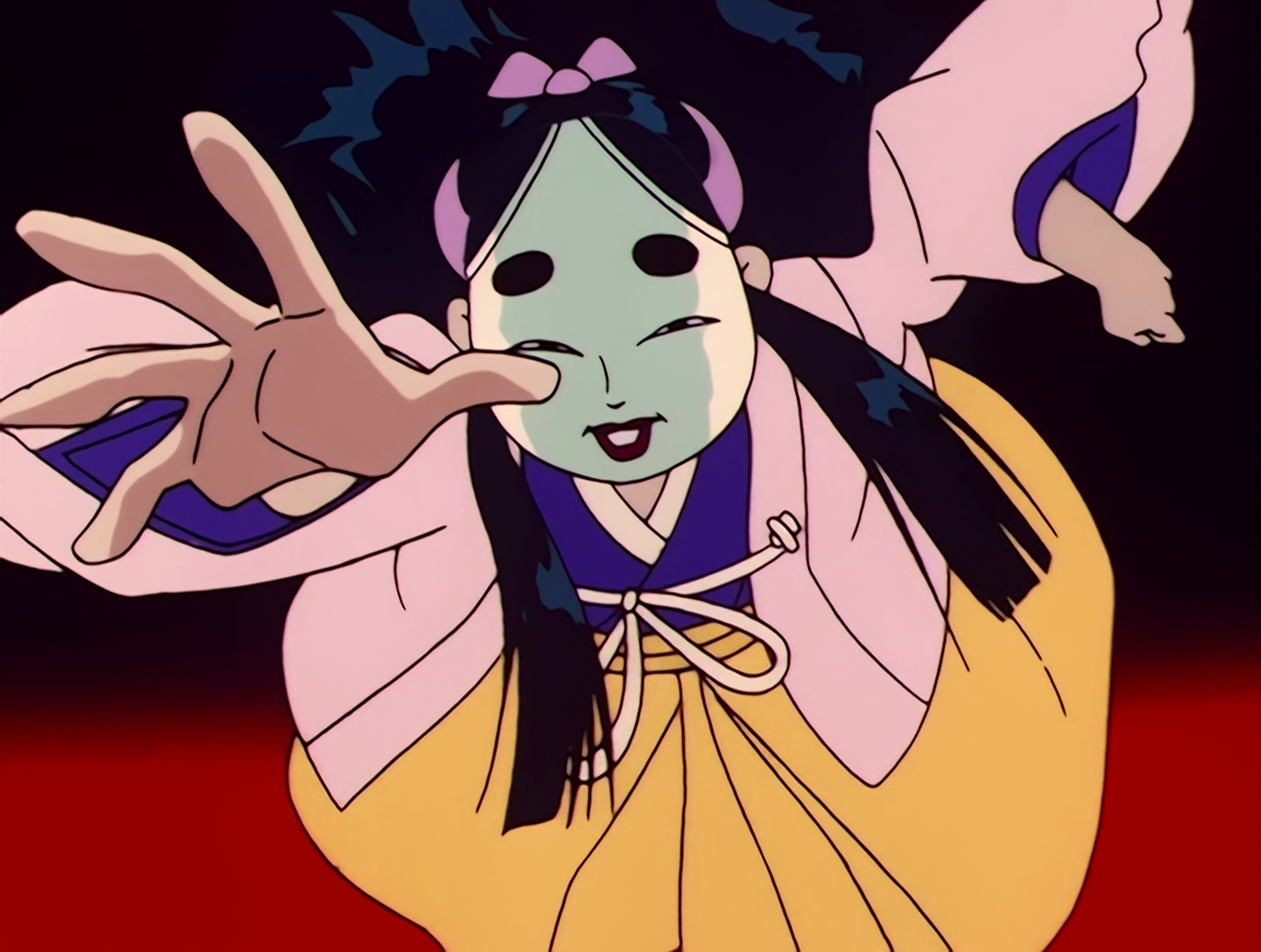 Yasha, a Youma from Sailor Moon episode 23. She’s a traditionally dressed Japanese lady wearing blue, yellow and pink. Her face is covered with a Noh mask, and she has long black hair. Aside from the mask she looks fairly human.